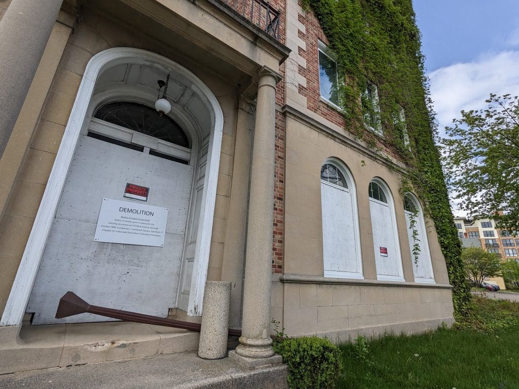 Shows a demolition sign at the dilapidated former Norwalk YMCA building at 340 West Ave.